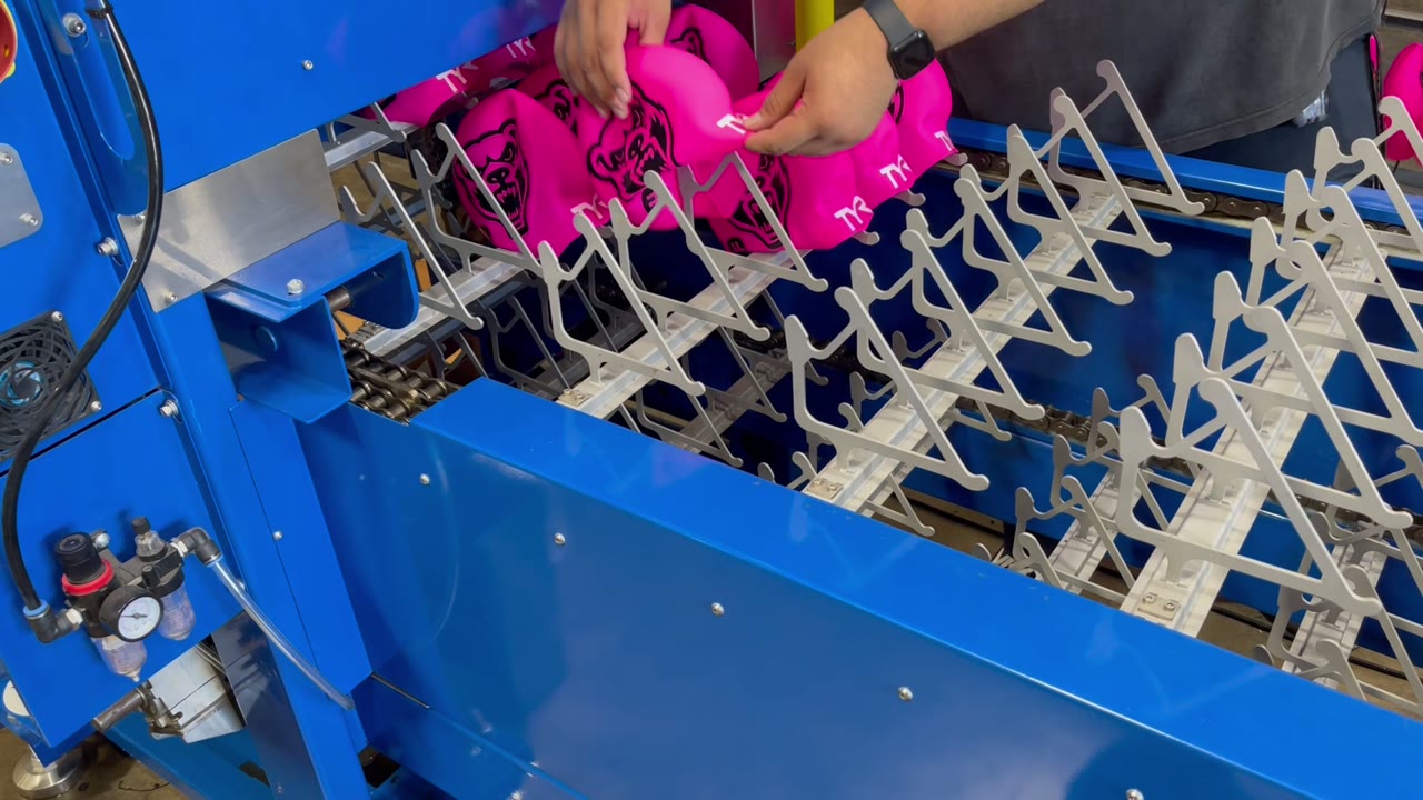ASPE vertical silicone swim cap curing dryer with printed caps loaded on the open-frame hangers